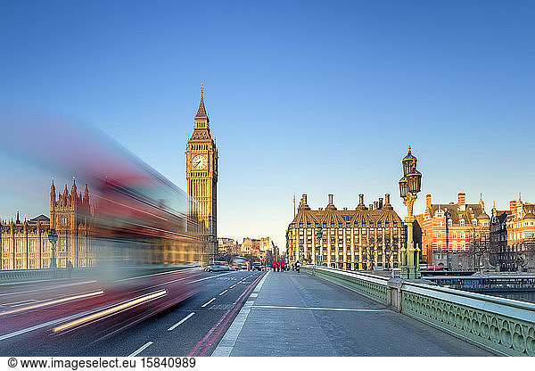 Double-decker bus passes on Westminster Bridge  in front of Westminster Palace and clock tower of Big Ben (Elizabeth Tower)  London  England  United Kingdom