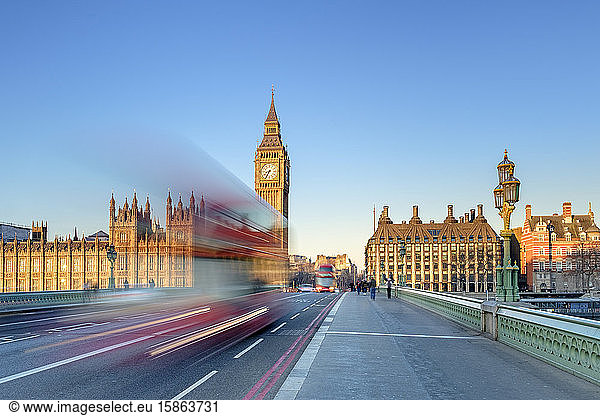 Double-decker bus passes on Westminster Bridge  in front of Westminster Palace and clock tower of Big Ben (Elizabeth Tower)  London  England  United Kingdom