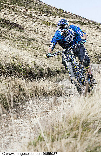 Downhill biker cruising down single track at end of day in Chamonix valley  Chamonix  Haute Savoie  France