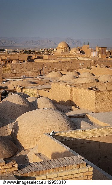 Downtown rooftops wind towers and landscape view of yazd city old town in iran.