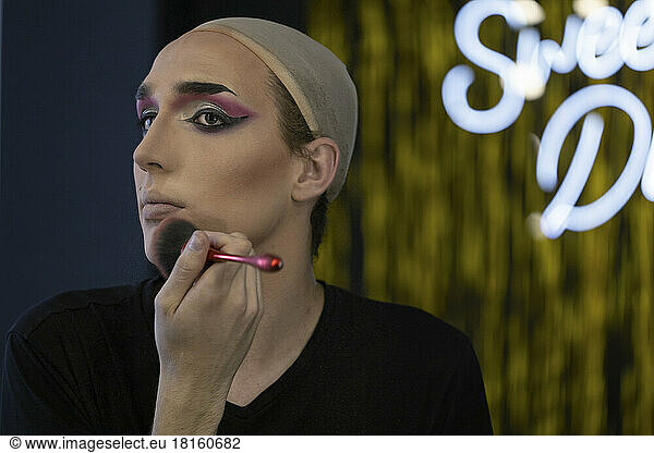 Drag queen doing make-up in dressing room