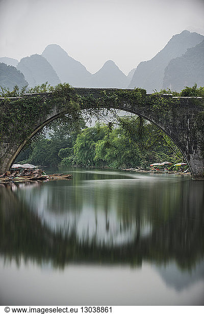 Dragon Bridge over Li River against mountains