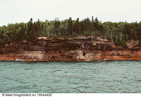 Dramatic cliffs  sea caves  and forest along the Lake Superior coast.