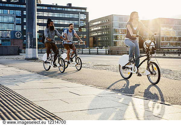 Drei Personen beim Radfahren in der Stadt