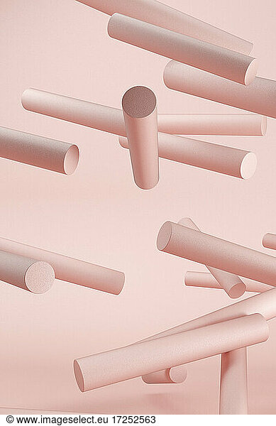 Dreidimensionales Rendering von rosa geometrischen Zylindern  die vor einem rosa Hintergrund schweben