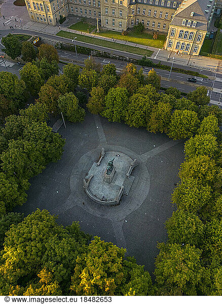 Drone view of King Karl's memorial statue amidst trees  Stuttgart  Germany