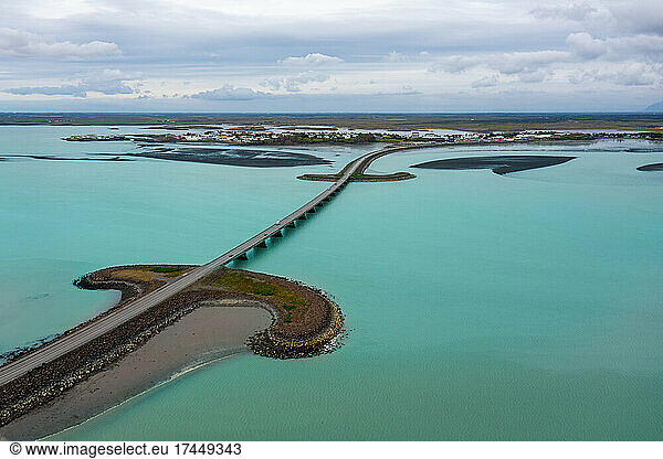 Drone view of long modern bridge over turquoise waters