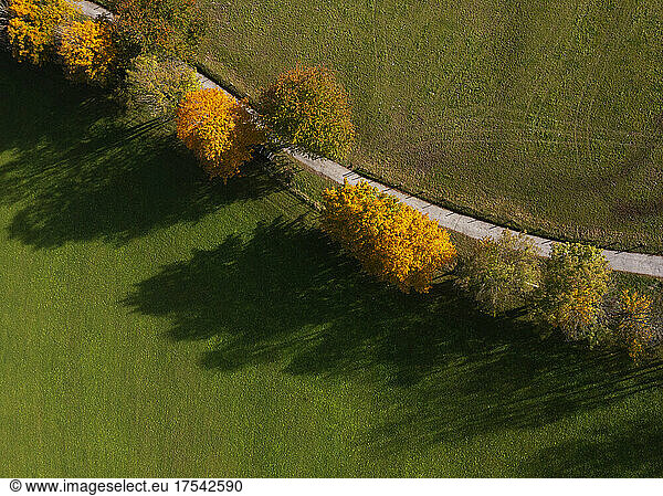 Drone view of treelined country road in autumn