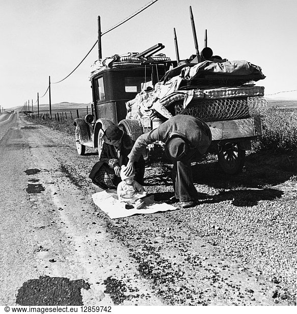 DROUGHT REFUGEES  1937. A destitute Missouri family of five with no money  a sick baby  and a broken down automobile alongside U.S. Highway 99 in San Joaquin County  California. Photograph by Dorothea Lange  February 1937.