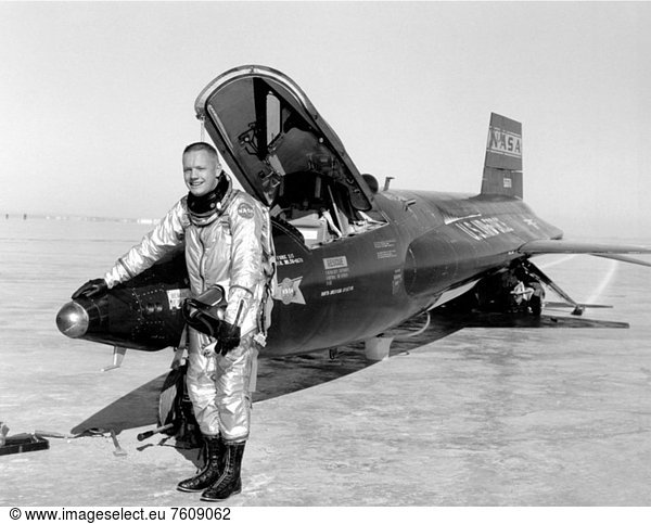 Dryden pilot Neil Armstrong is seen here next to the X_15 ship 1 56_6670 after a research flight. Armstrong made his first X_15 flight on November 30  1960  in the 1 X_15. He made his second flight on December 9  1960  in the same aircraft. This was the first X_15 flight to use the ball nose  which provided accurate measurement of air speed and flow angle at supersonic and hypersonic speeds. The servo_actuated ball nose can be seen in this photo in front of Armstrong´s right hand. The X_15 employed a non_standard landing gear. It had a nose gear with a wheel and tire  but the main landing consisted of skids mounted at the rear of the vehicle. In the photo  the left skid is visible  as are marks on the lakebed from both skids. Because of the skids  the rocket_powered aircraft could only land on a dry lakebed  not on a concrete runway.
