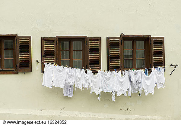 Drying underwear on a washing line in front of a house