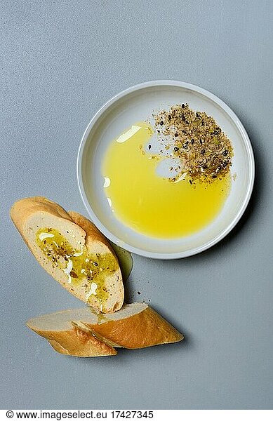 Dukkah  Arabic spice mix and olive oil in bowl  slices of bread