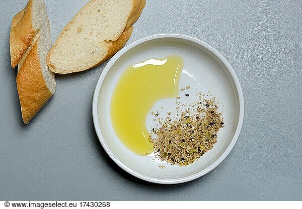 Dukkah  Arabic spice mix and olive oil in bowl  slices of bread