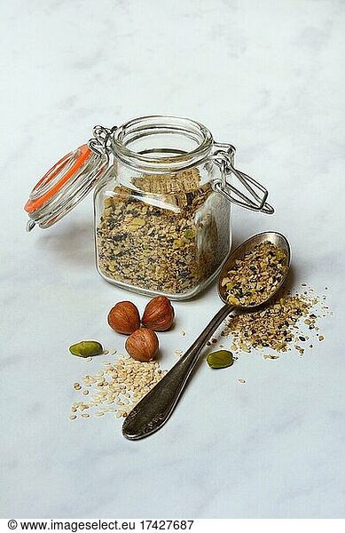 Dukkah  Arabic spice mix in glass container and spoon  nuts