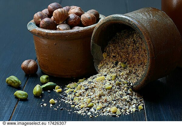 Dukkah  Arabic spice mixture in clay pots and nuts