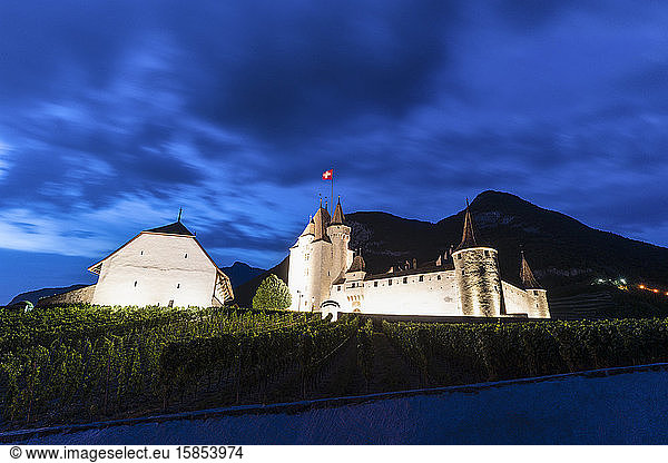 Dusk over illuminated Aigle Castle  canton of Vaud  Switzerland