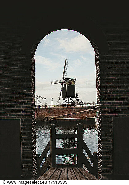 dutch windmill between black arch