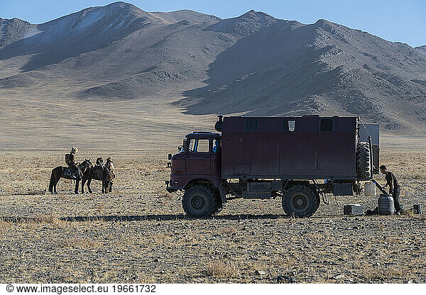Eagle hunters on horses and truck Ã?Â Olgiy Ã?Â Bayan-Olgiy  Mongolia