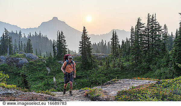 Early morning hiker at the alpine track on a local vacation trip