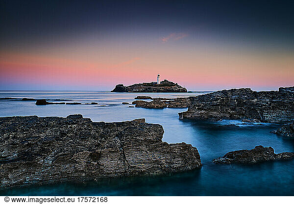 Early Morning Sunrise of Lighthouse With Rocks