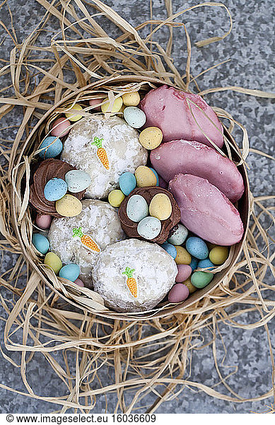 Easter cookies with pink and carrot decorations  chocolate cupcakes and mini chocolate eggs