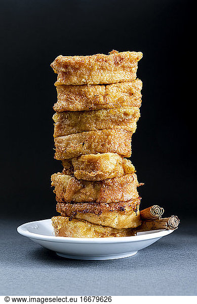 Easter dessert.Traditional homemade Spanish French toast on dark background in vertical format.