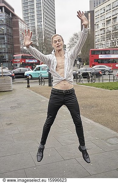 Eccentric man jumping on the street. London  England.