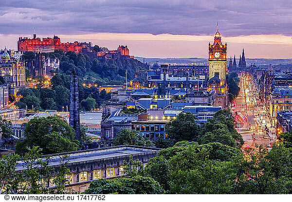 Edinburgh skyline lit up at dawn.
