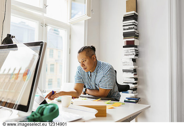 Editor using digital tablet in office
