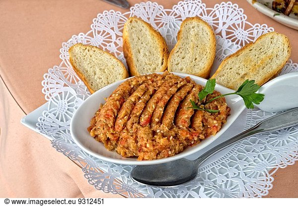 Eggplant ´Caviar´  Russian Style. Eggplant Odessa Style in a Serving Bowl  Surrounded by Toasted Bread Slices. Served in Brighton Beach  Brooklyn  New York  Russian Neighborhood.