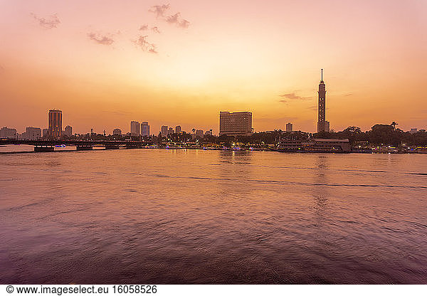 Egypt  Cairo  Cairo Tower on Gezira Island seen across river Nile at sunset