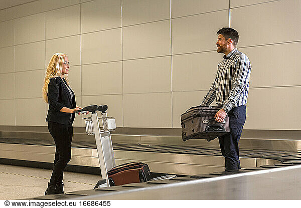 Ehepaar nimmt Gepäck vom Förderband