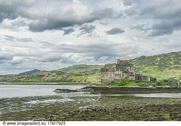 Eilan Donan  a remote castle on a tidal island with low tide.