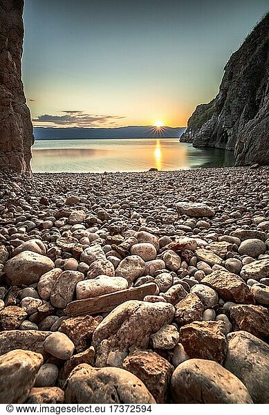 Ein kleiner Steinstrand am Meer,  vom Felsen eingerahmt,  am Morgen,  Sonnenaufgang. Ruhiges wasser bei Vrbnik,  Insel,  Krk,  Kroatien,  Europa