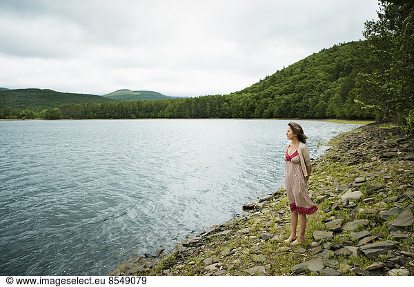 Eine Frau in freier Natur  an einem Bergsee.