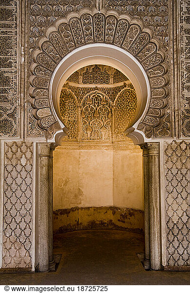 Elaborate arched alcove inside the Ali ben Youssef Medersa in the Marrakech medina  Morocco.