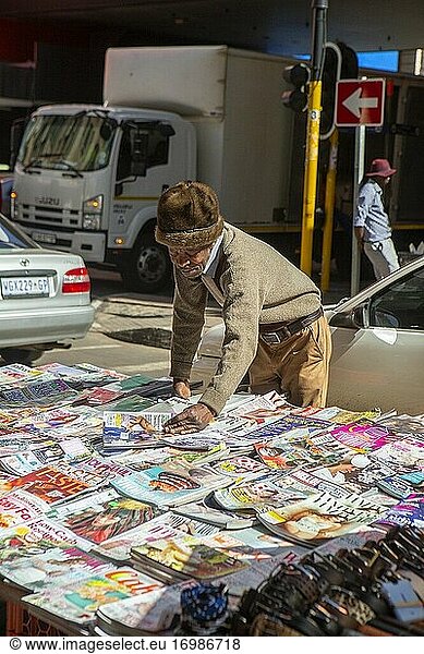 Elderly African man informal trader selling magazines  Johannesburg  South Africa