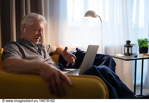 Elderly man making video call to family