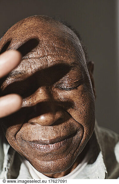 Elderly man with eyes closed in studio