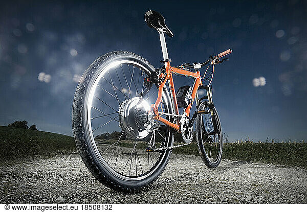 Electric bicycle standing on field
