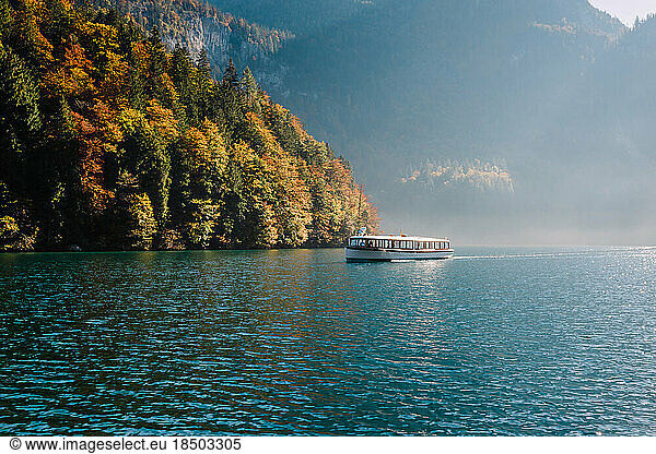 electric boat sailed through the blue waters of Lake Königssee illumin