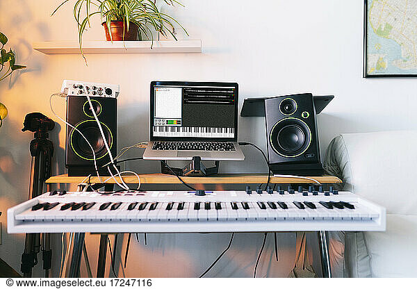 Electric piano and laptop at recording studio