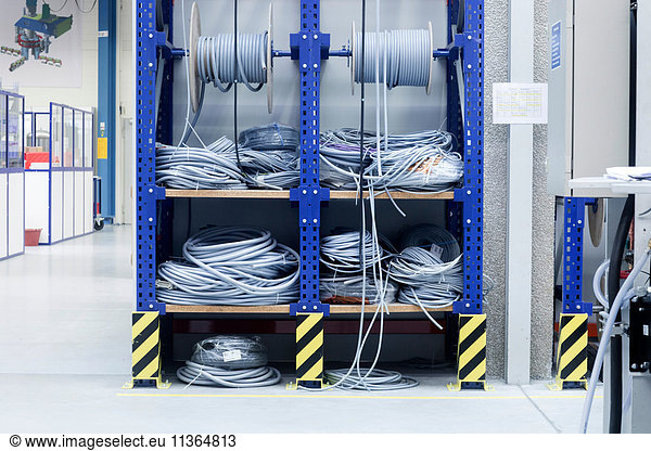 Electrical cables on shelf in engineering plant