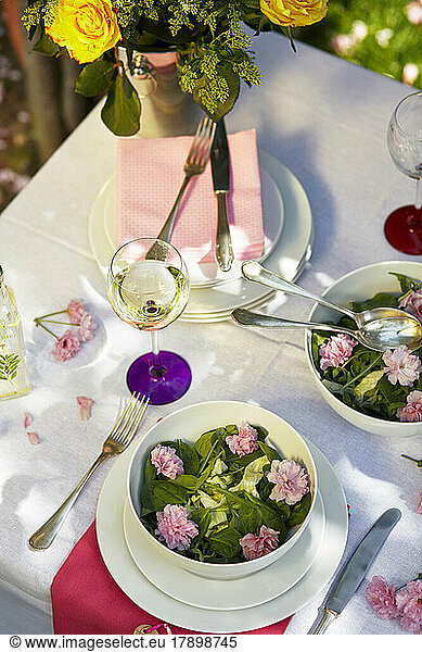Elegant spring decorated table with edible flowers