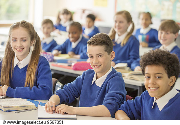 Elementary school children smiling in classroom