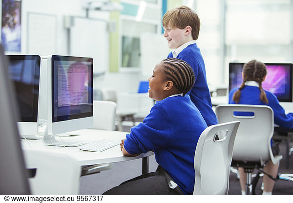 Elementary school children working with computers