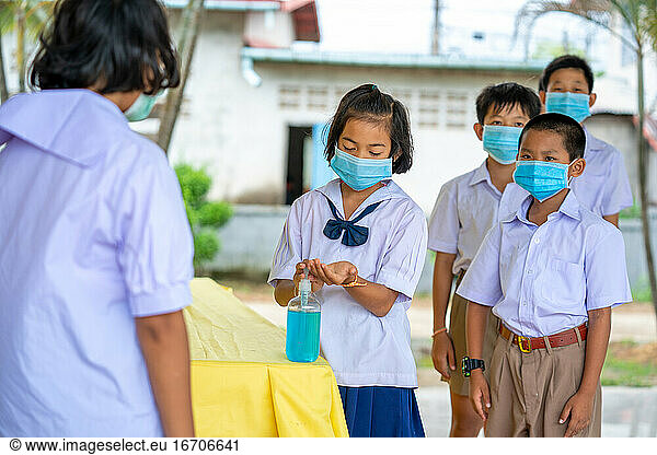 Elementary school students wearing hygienic mask to prevent the