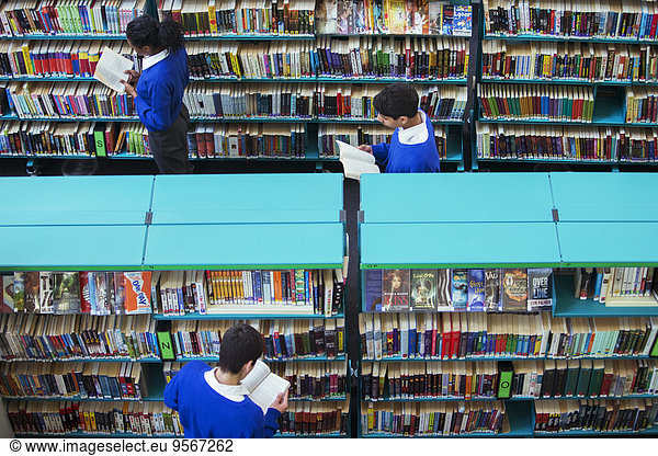 Elevated view of high school students browsing books in library