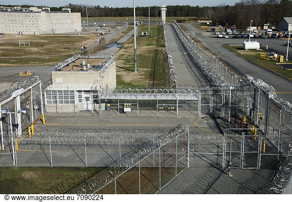 Elevated view of Prison grounds  Entrance Gate  and the vehicle lock  perimeter fence and watch tower at a Correctional Facility.