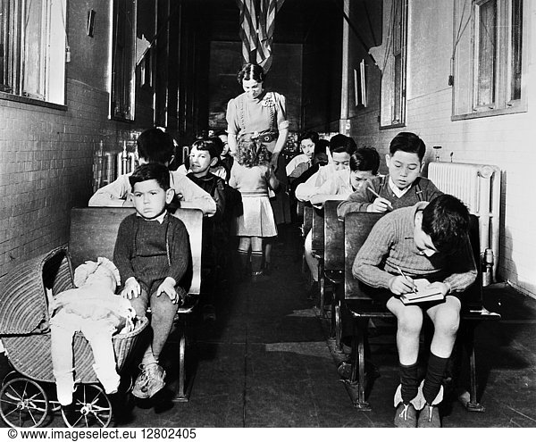 ELLIS ISLAND: CHILDREN  1940. Children of detained immigrants in a hallway classroom at Ellis Island  New York City. Photograph  1940.